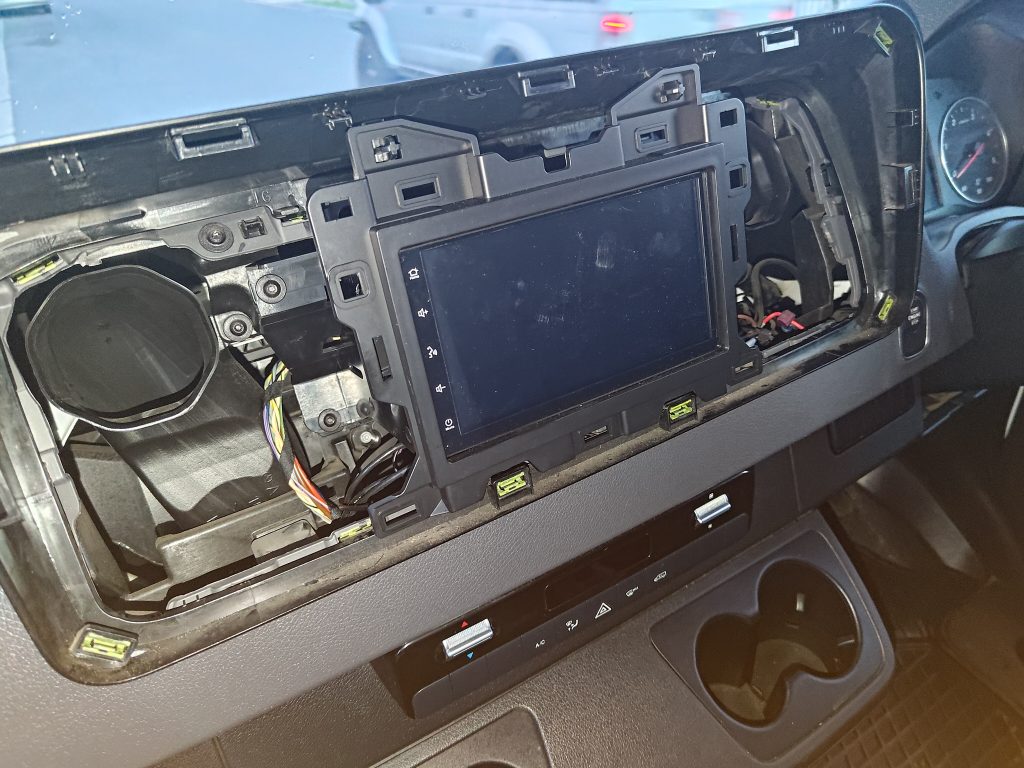 Mercedes Sprinter dashboard partially disassembled during infotainment and workstation installation.