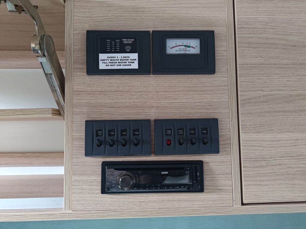 Interior power control panel inside the Mobile Dojo, showing battery meters, switches, and system monitoring controls.