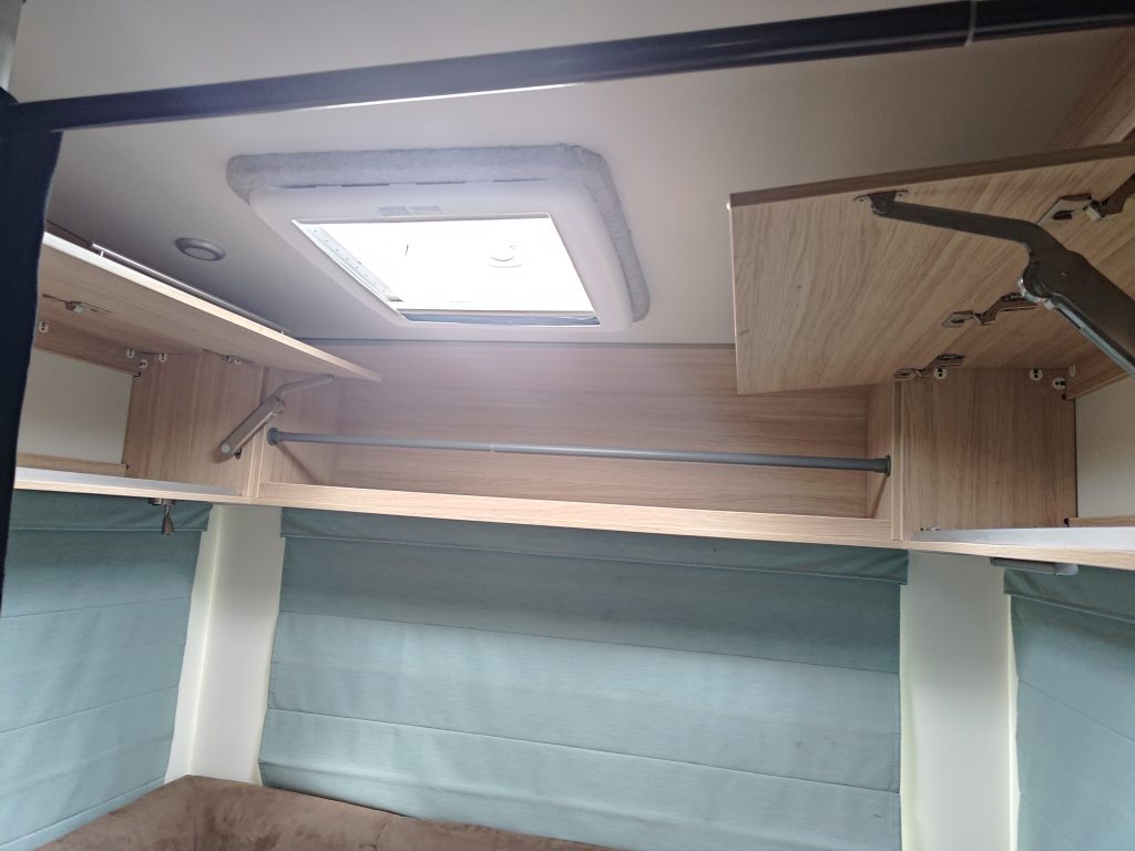 Upper interior storage and shelving inside the Mobile Dojo, positioned beneath a roof skylight for natural light.
