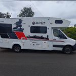 Full side profile of the Mobile Dojo featuring the completed NinjaWeb wrap and visual identity.