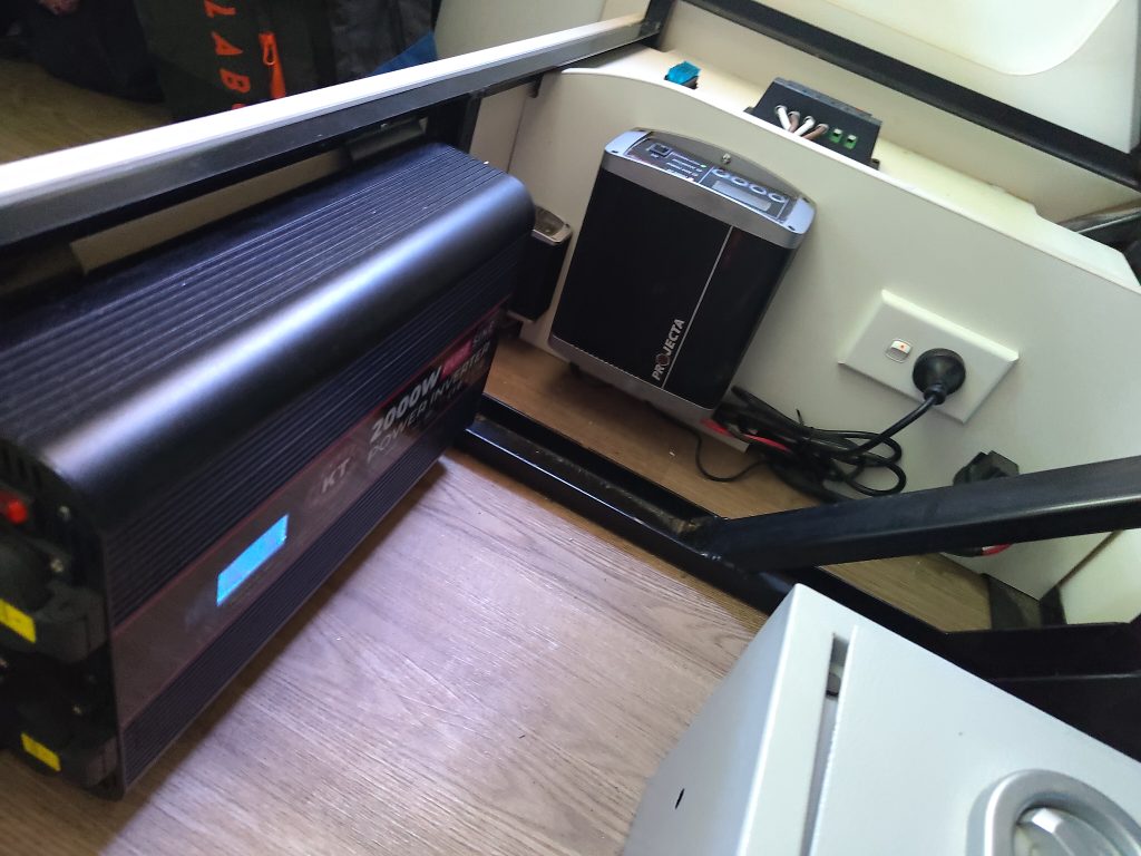 Installed inverter and power hardware inside the Mobile Dojo, forming the core electrical system for off-grid operation.